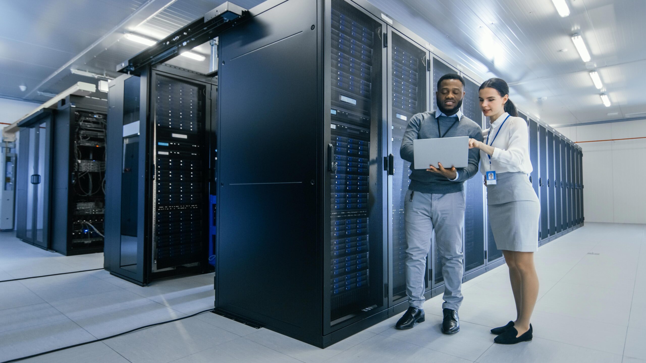 Two Employees Discuss Small Business Continuity In Colocation Data Center